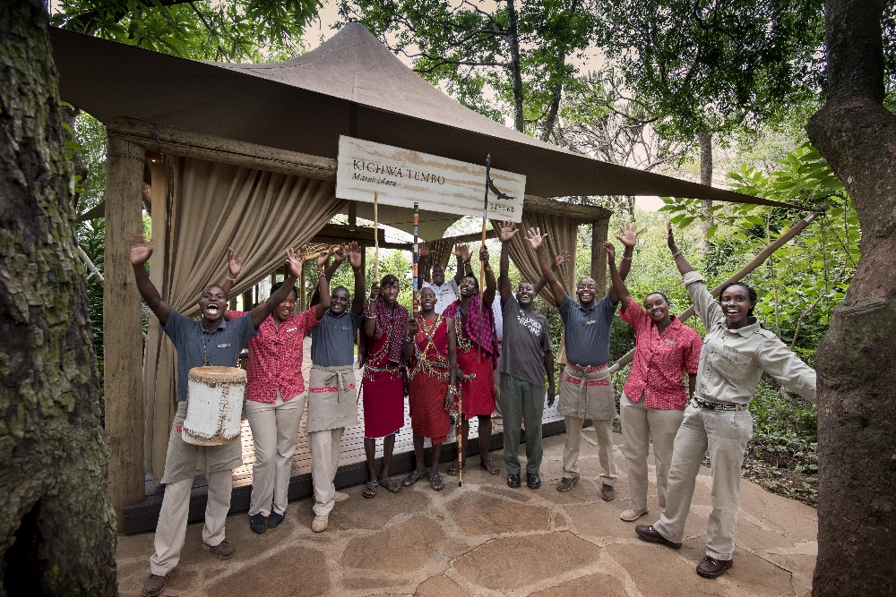 A group of staff welcoming visitors to Kichwa Tembo luxury tents lodge