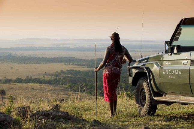 Masai Mara gudie and safari truck overlooking the safari