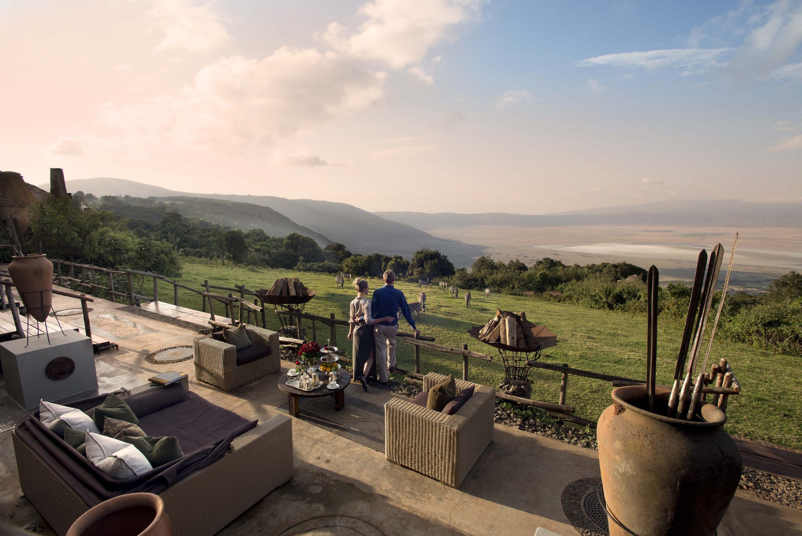 A couple looking at the view from the deck of a lodge on the rim of Ngorongoro Crater