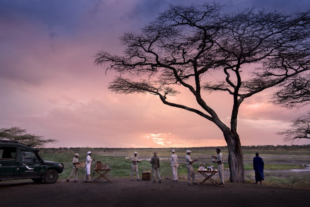 Safari group watching the sunset at andBeyond Savute Under Canvas camp