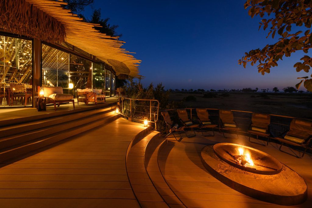 A view of the outdoors deck and fireplace at Wilderness Jao Camp