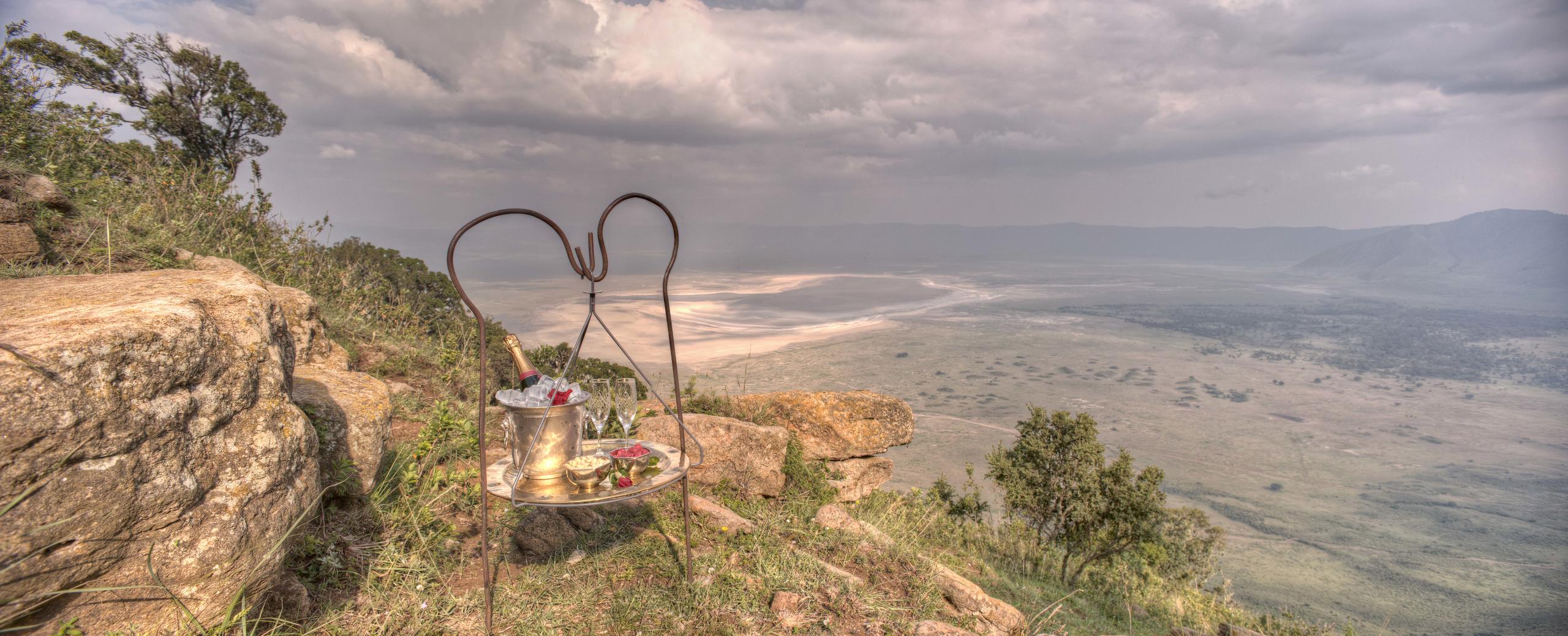 A bottle of champagne and a pair of glasses waiting by the rim of Ngorongoro Crater