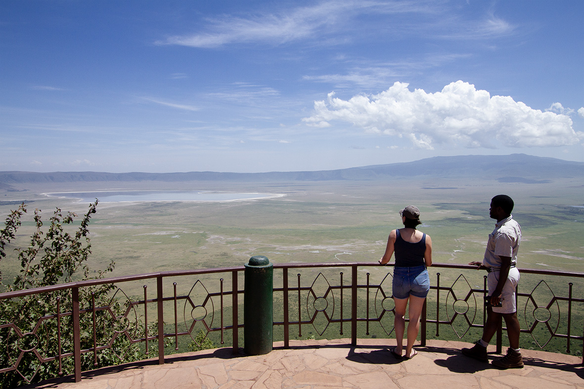 A tourist and guide looking at the view from the top of Ngorongoro Crater