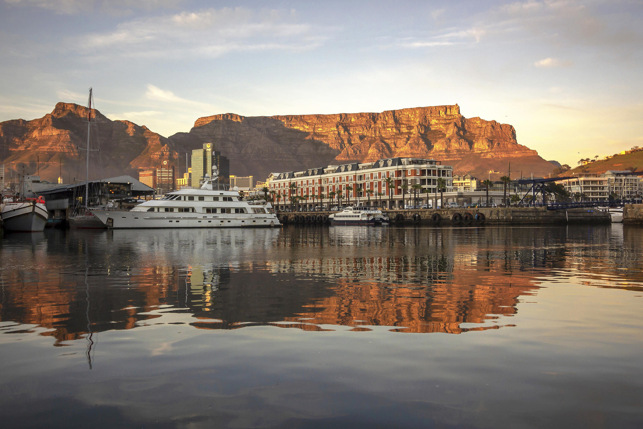 A view of the V&A waterfront from the water during sunset