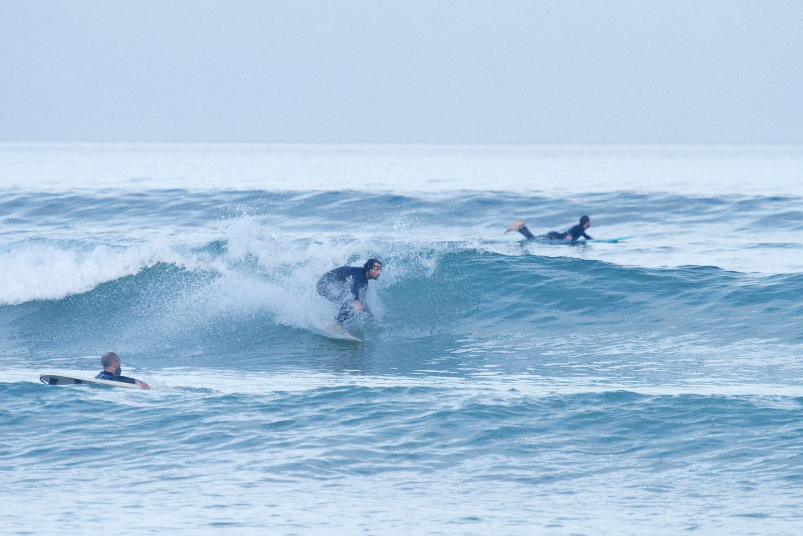 Surfers riding waves off the coast of one of Cape Town's many beaches