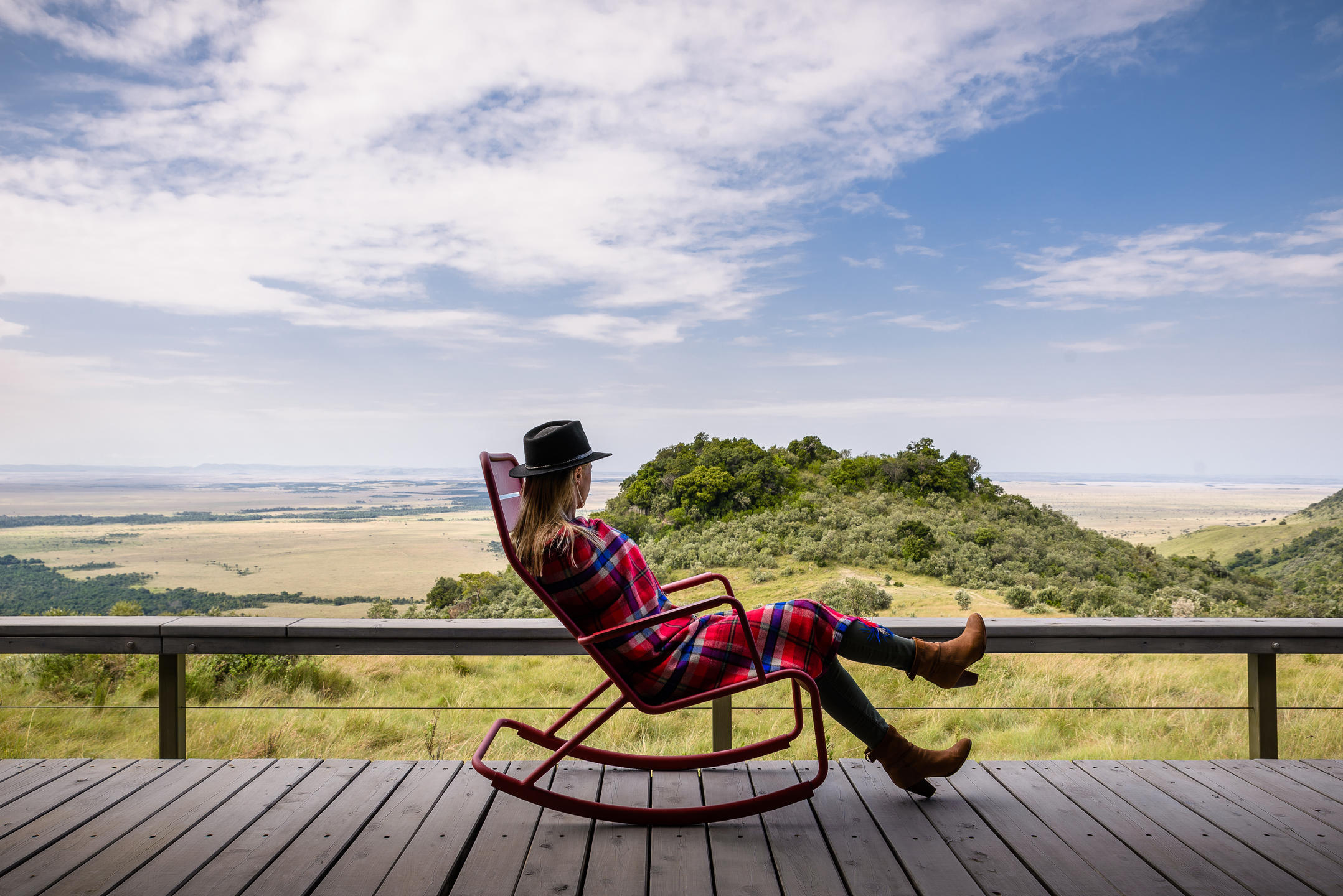 A person lounging in a chair at Angama Mara, Masai Mara, Kenya