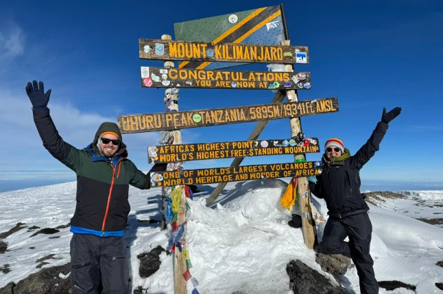 Ubuntu Travelers, Allison and Josh, at the summit of Mount Kilimanjaro, Tanzania.