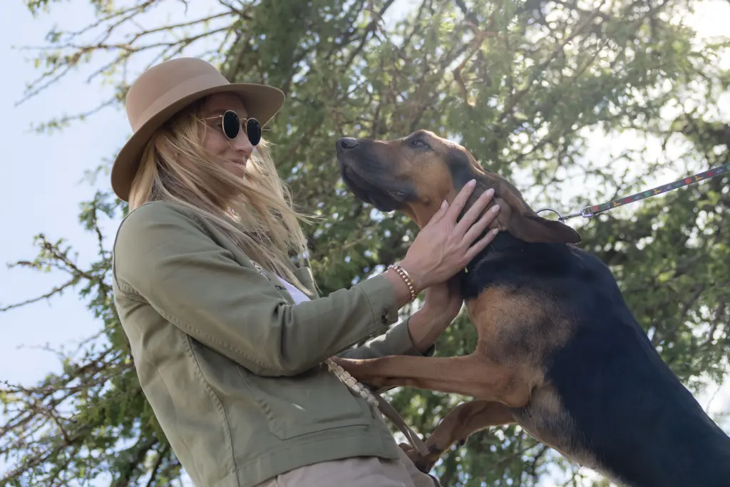 Co-founder and Travel Design Specialist, Leah Green, greeting a member of the canine unit is Loisaba Conservancy, Kenya. 