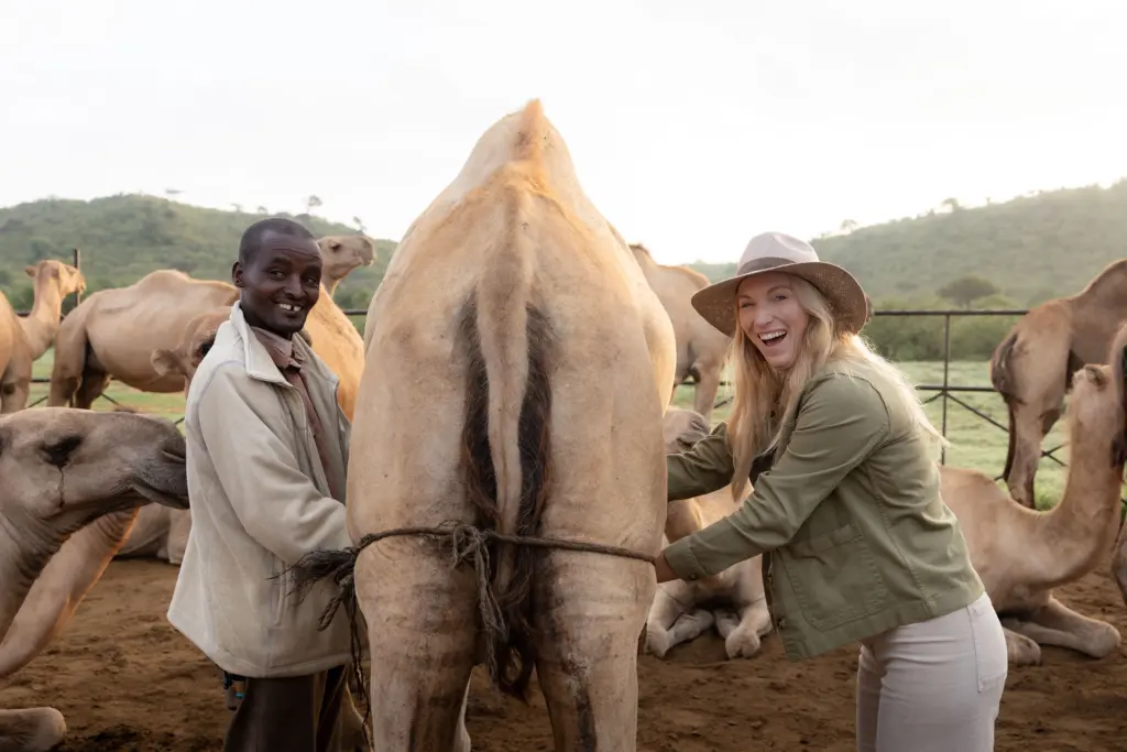 Co-founder and Travel Design Specialist, Leah Green, miking a camel at andbeyond Suyian, Laikipia Plateau, Kenya 